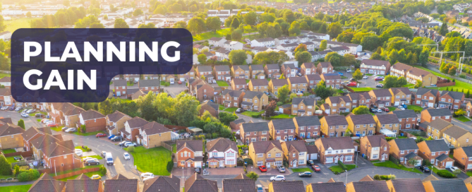 Aerial view of village with overlaying words saying 'Planning Gain'