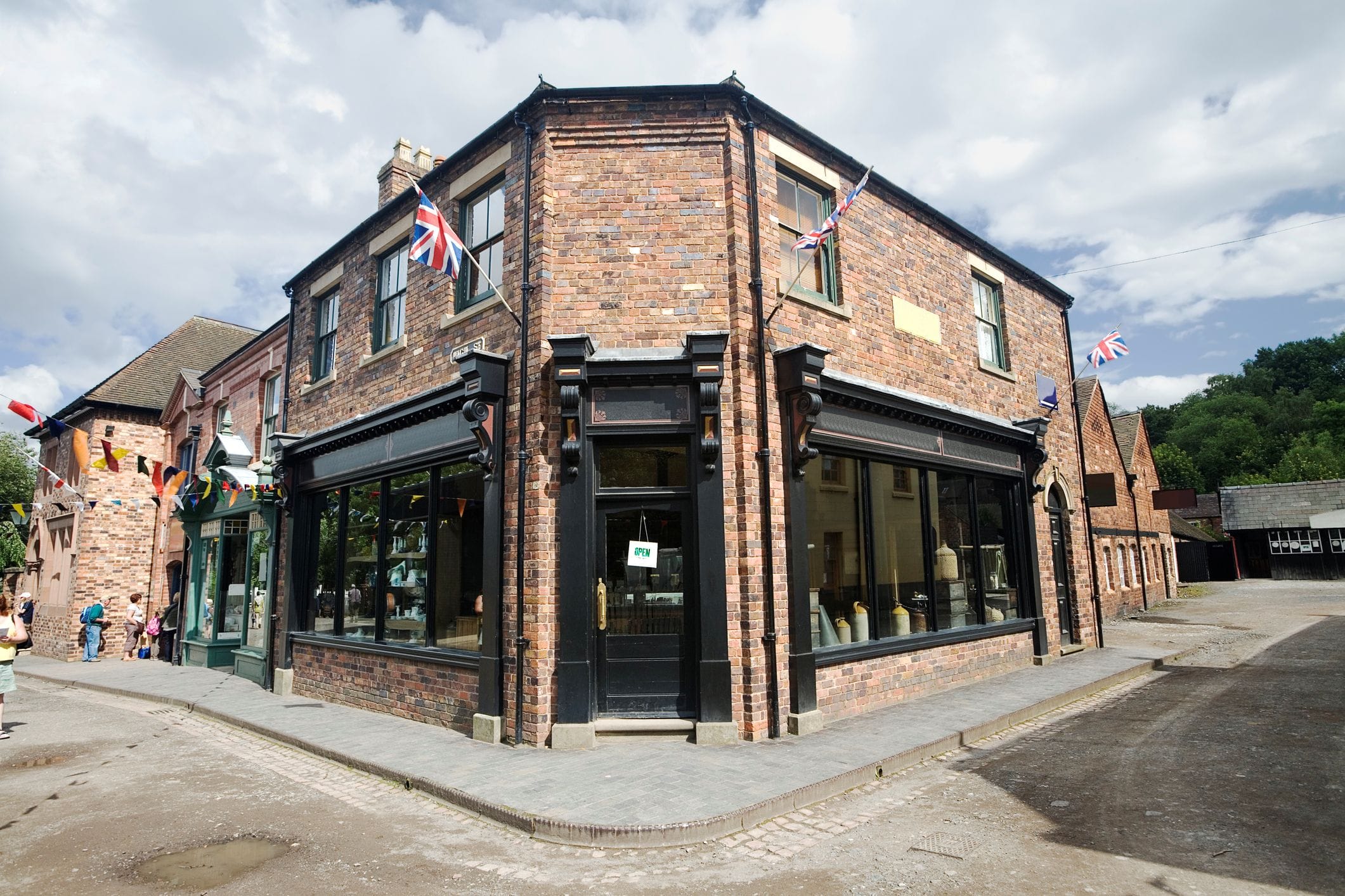 Retail unit with flats and rooms above.